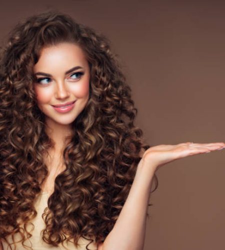 Beautiful woman with voluminous curly hairstyle